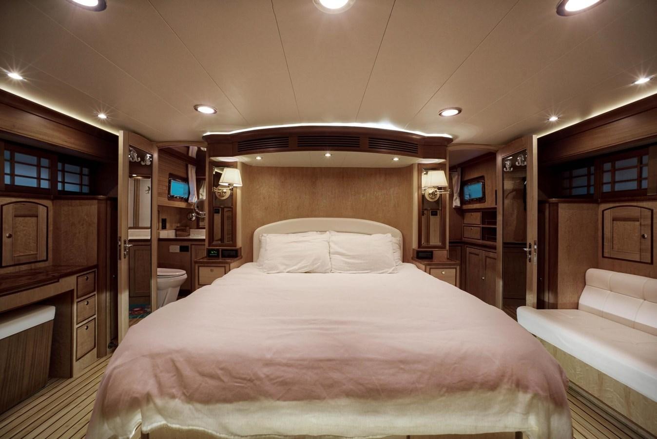 a bedroom with a bed and a desk aboard BEN'S BARGE Yacht for Sale