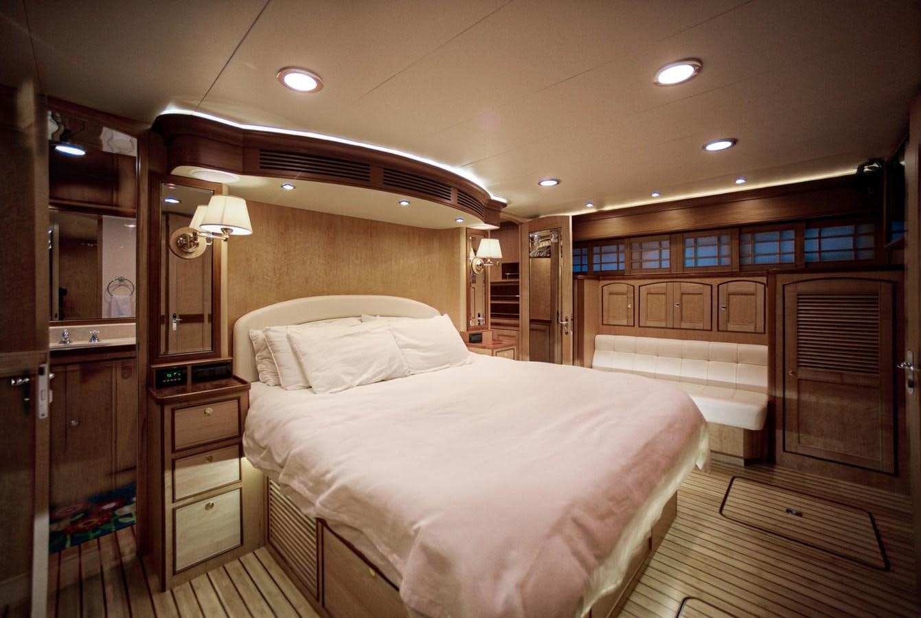 a bedroom with a bed and a mirror aboard BEN'S BARGE Yacht for Sale