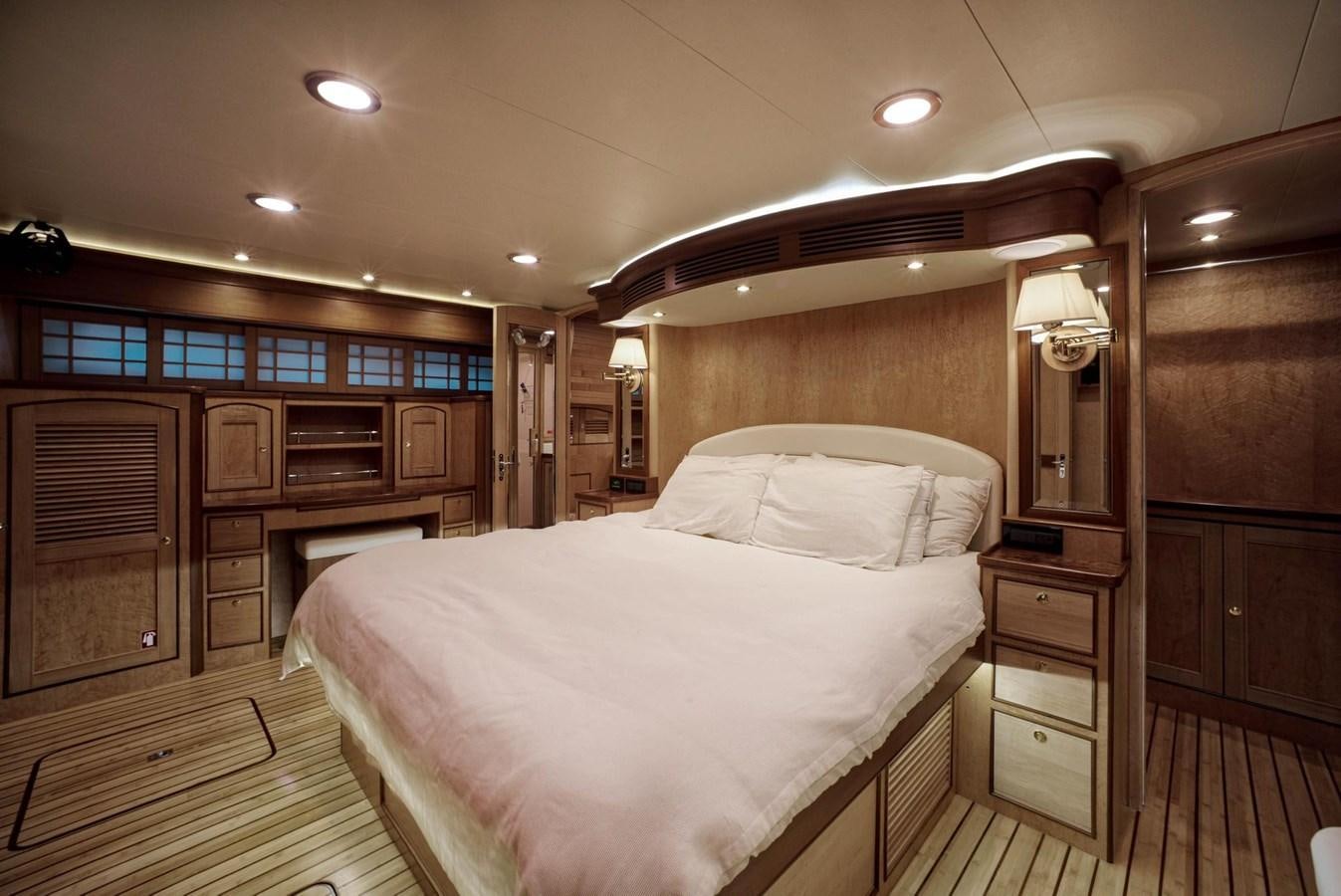 a bedroom with a bed and cabinets aboard BEN'S BARGE Yacht for Sale