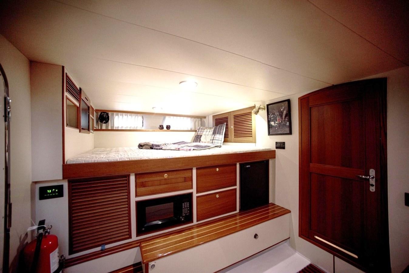 a kitchen with wooden cabinets aboard BEN'S BARGE Yacht for Sale