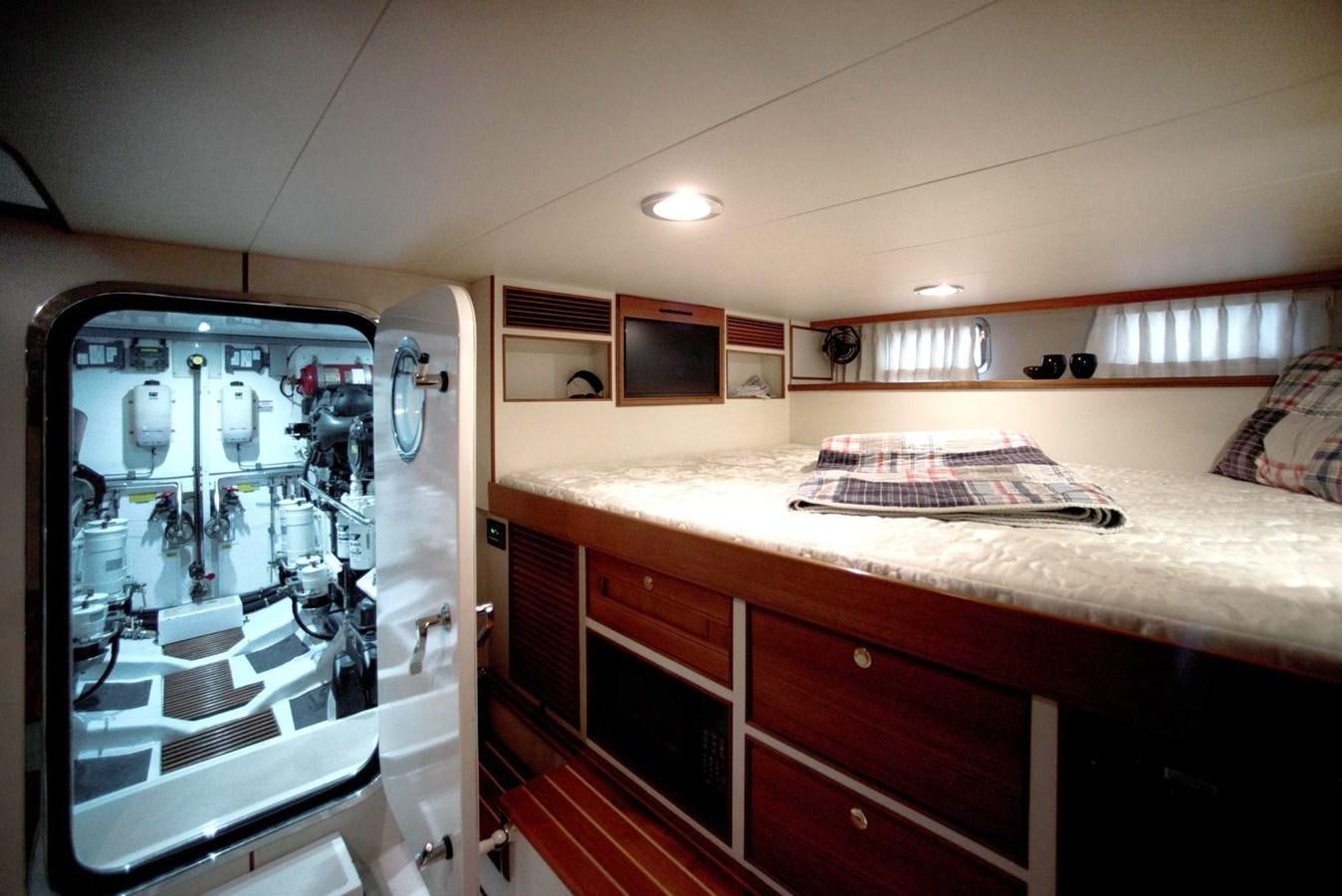 a bedroom with a bed and a desk aboard BEN'S BARGE Yacht for Sale
