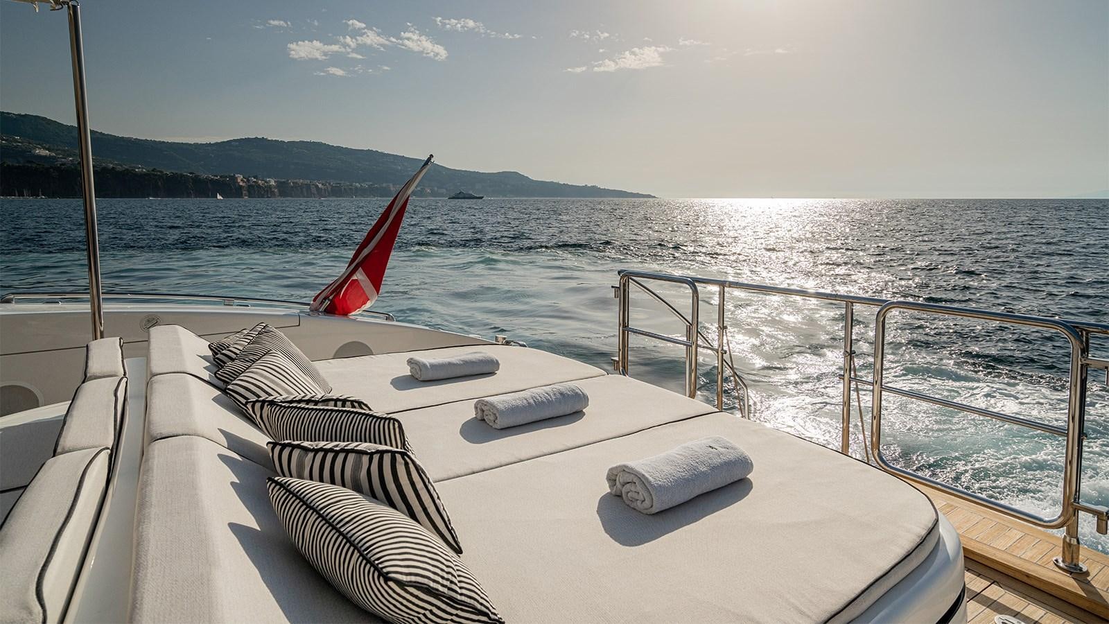 a boat with a flag on the front aboard DEVA I Yacht for Sale