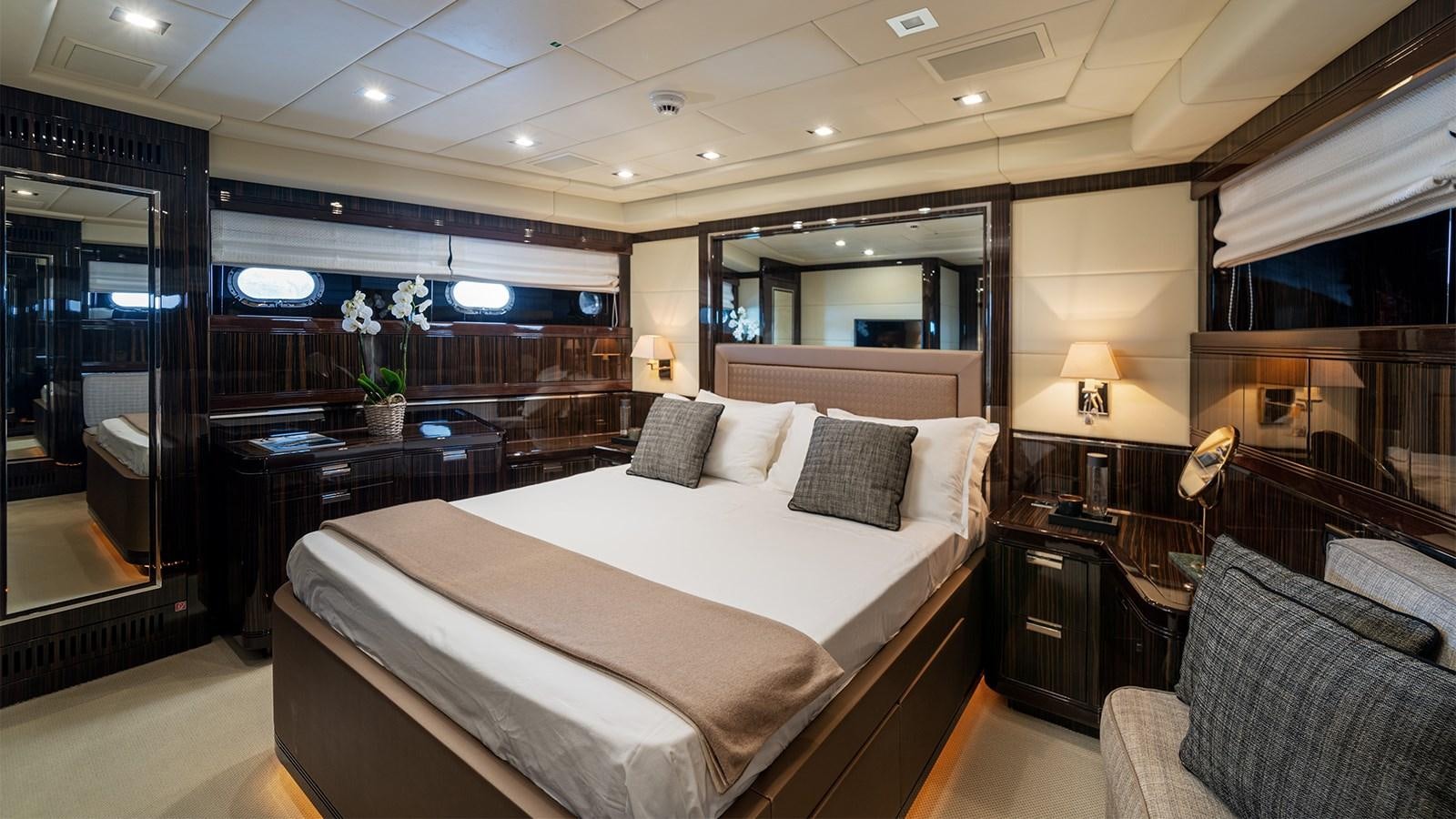 a hotel room with a bed and a desk aboard DEVA I Yacht for Sale