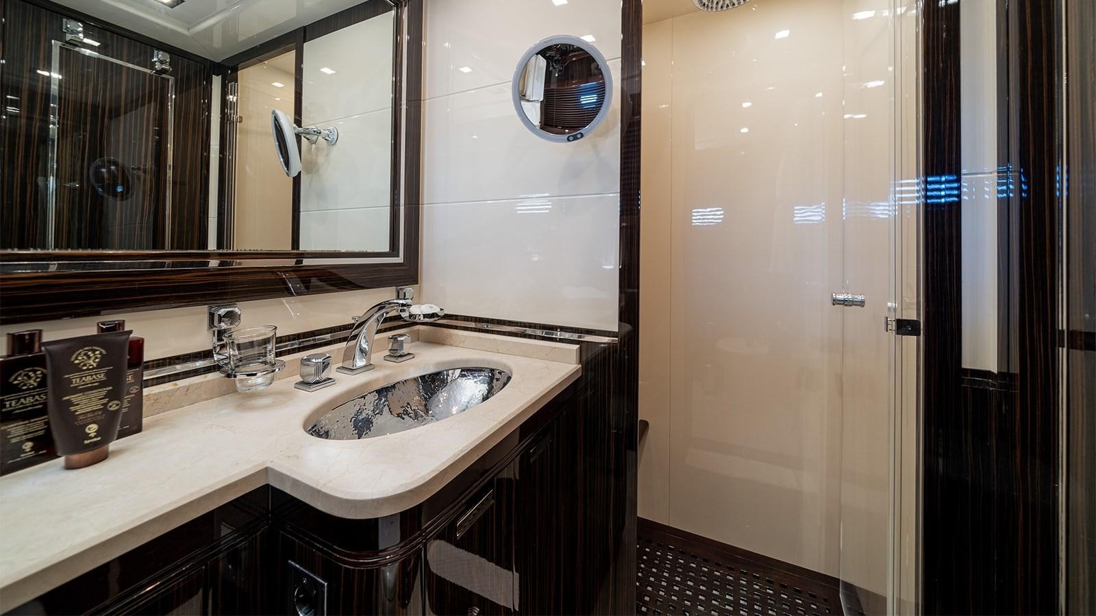 a bathroom with a sink and a mirror aboard DEVA I Yacht for Sale