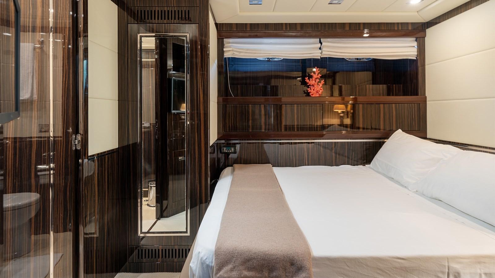 a room with a bed and a table aboard DEVA I Yacht for Sale