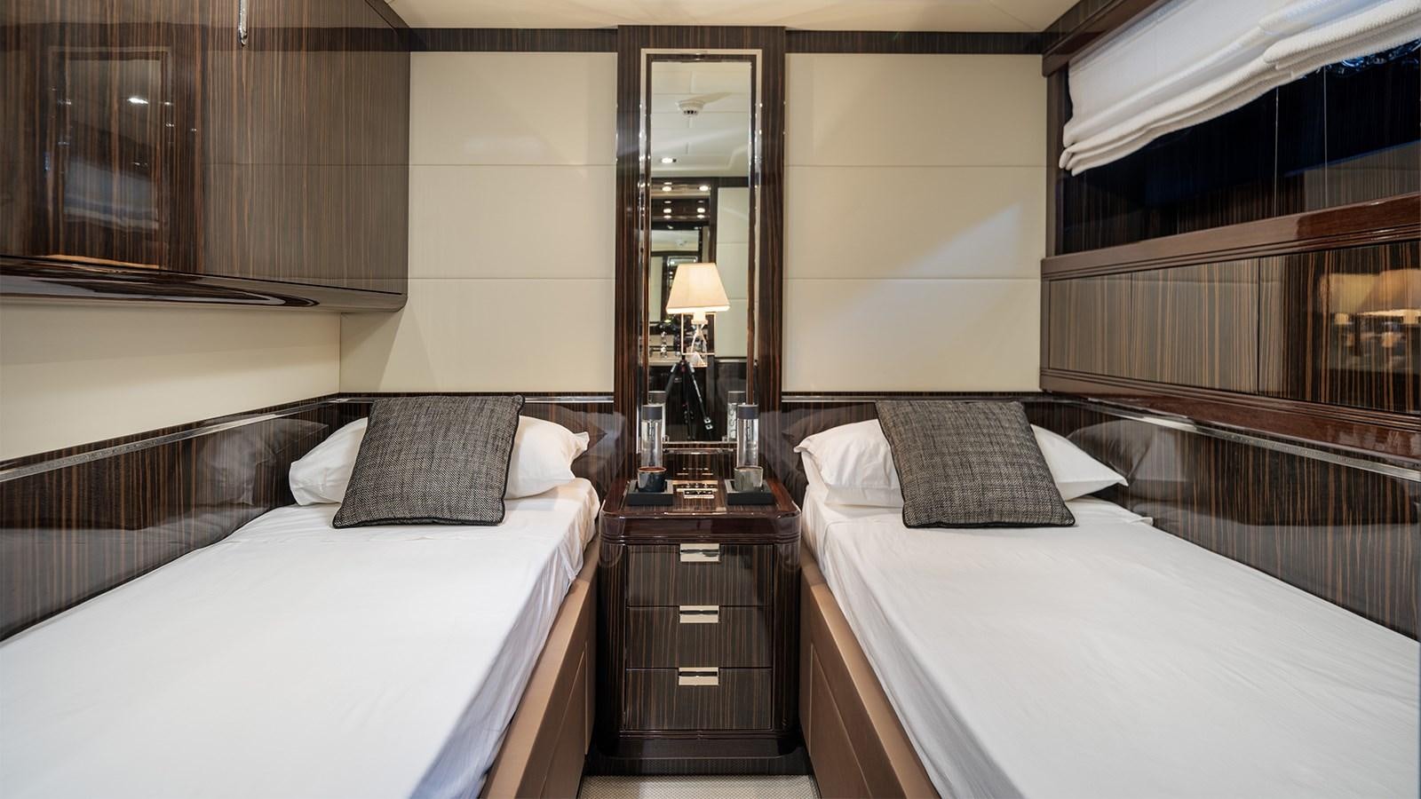 a room with two beds aboard DEVA I Yacht for Sale