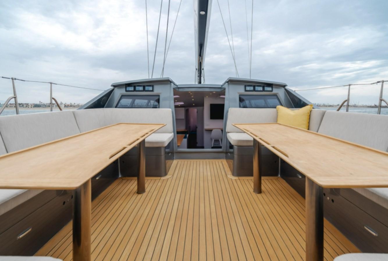 a deck with a boat and a deck with a deck and a large boat in the water aboard AANDEEL Yacht for Sale