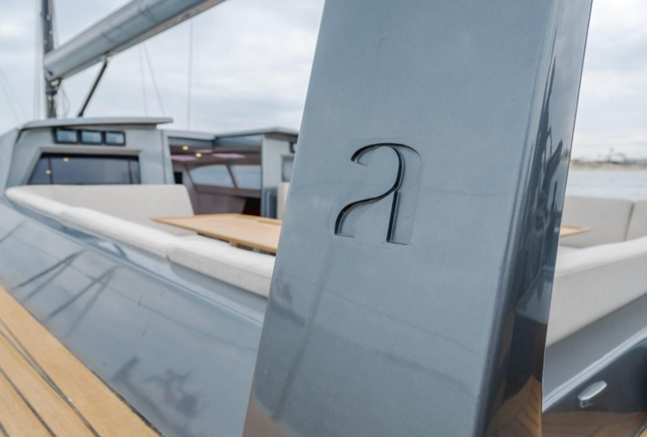 a white boat with a black symbol on the front aboard AANDEEL Yacht for Sale