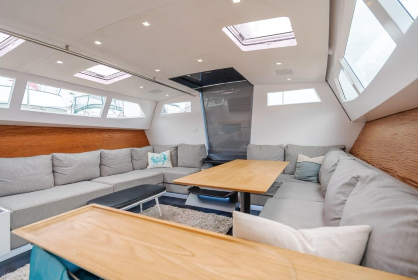a living room with a couch and a table aboard AANDEEL Yacht for Sale