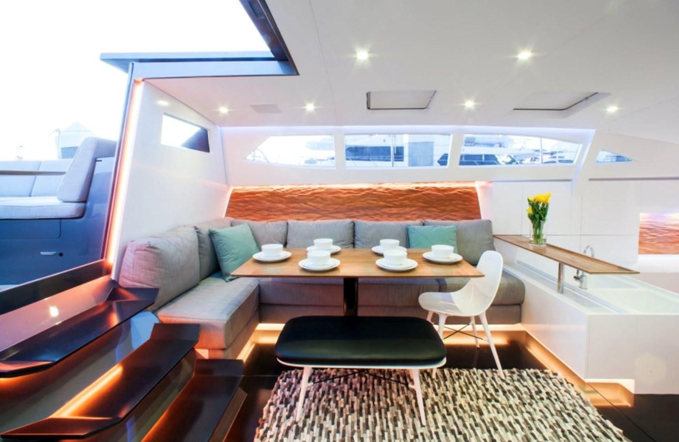 a room with a table and chairs aboard AANDEEL Yacht for Sale