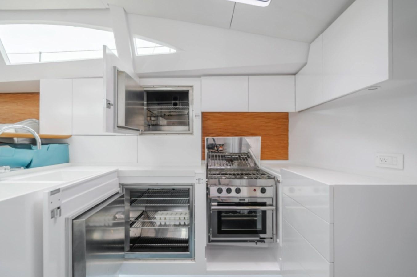 a kitchen with an oven and a microwave aboard AANDEEL Yacht for Sale
