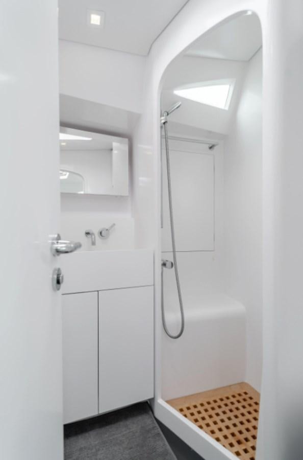 a white bathroom with a white door aboard AANDEEL Yacht for Sale