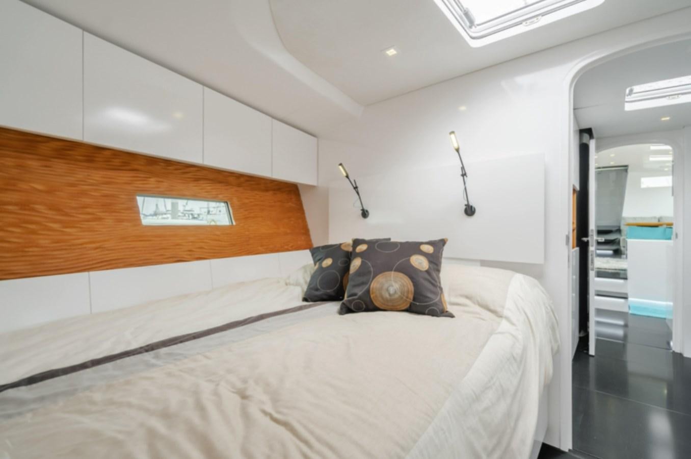 a bed with a white sheet and pillows on it aboard AANDEEL Yacht for Sale