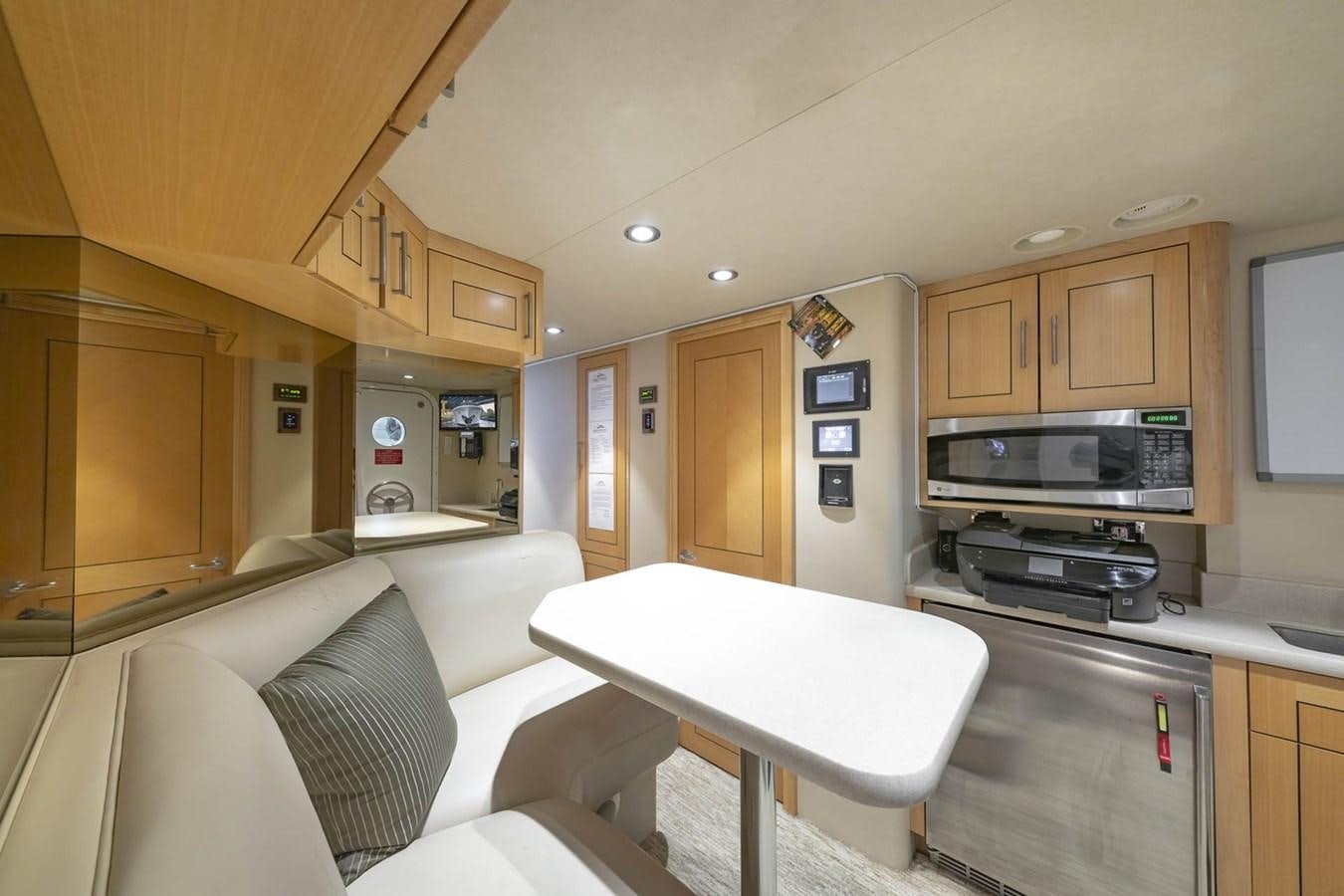a kitchen with a table and a couch aboard SIMPLICITY Yacht for Sale