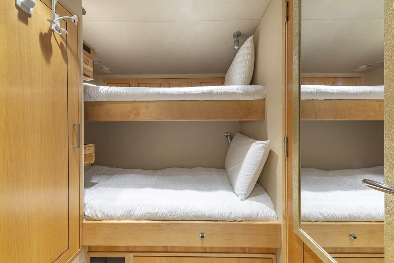 a bunk bed with white sheets aboard SIMPLICITY Yacht for Sale