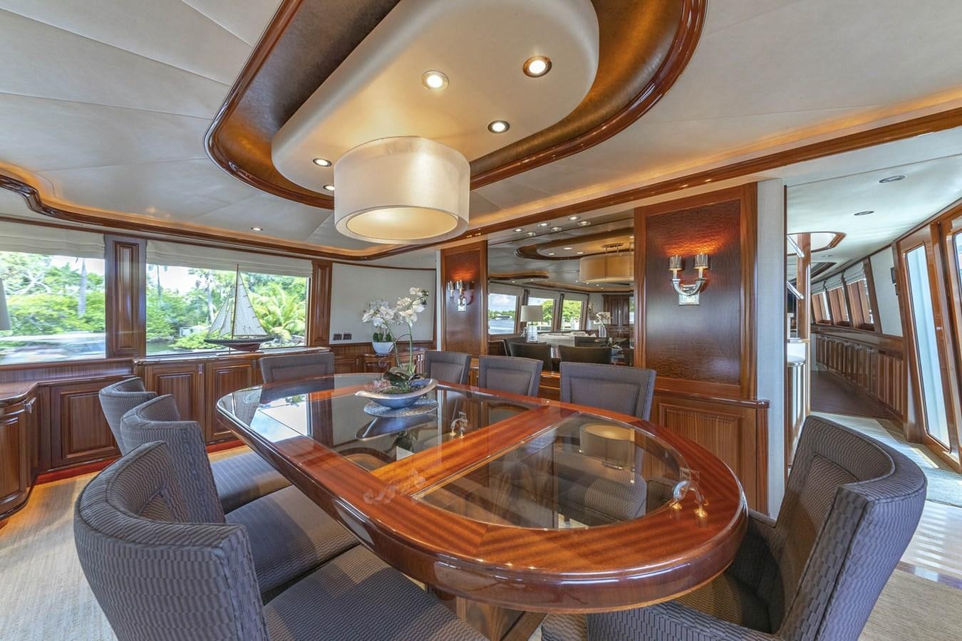 a large living room with a wood table and chairs aboard SIMPLICITY Yacht for Sale