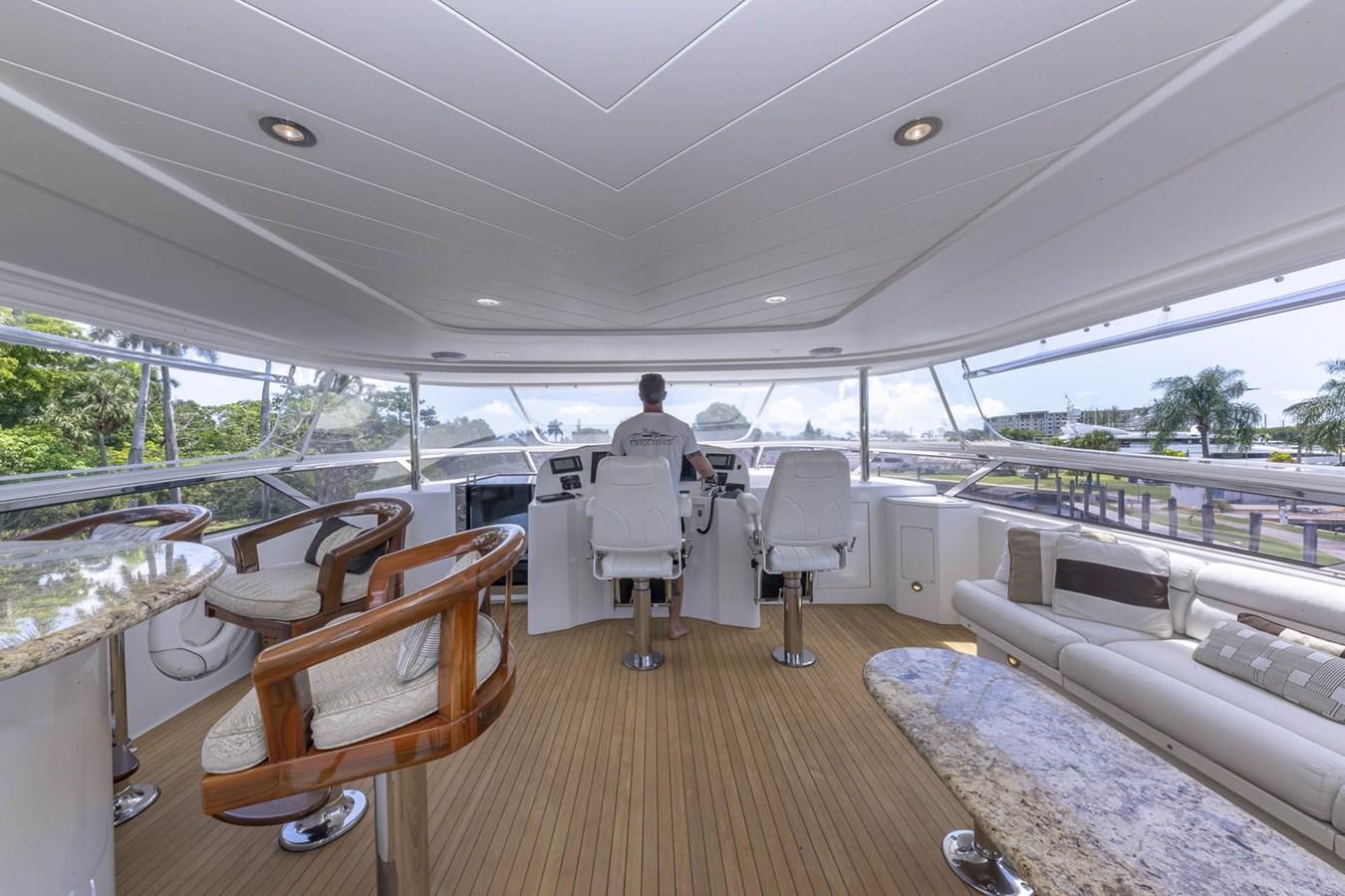 a person sitting in a chair on a deck looking out over the water aboard SIMPLICITY Yacht for Sale