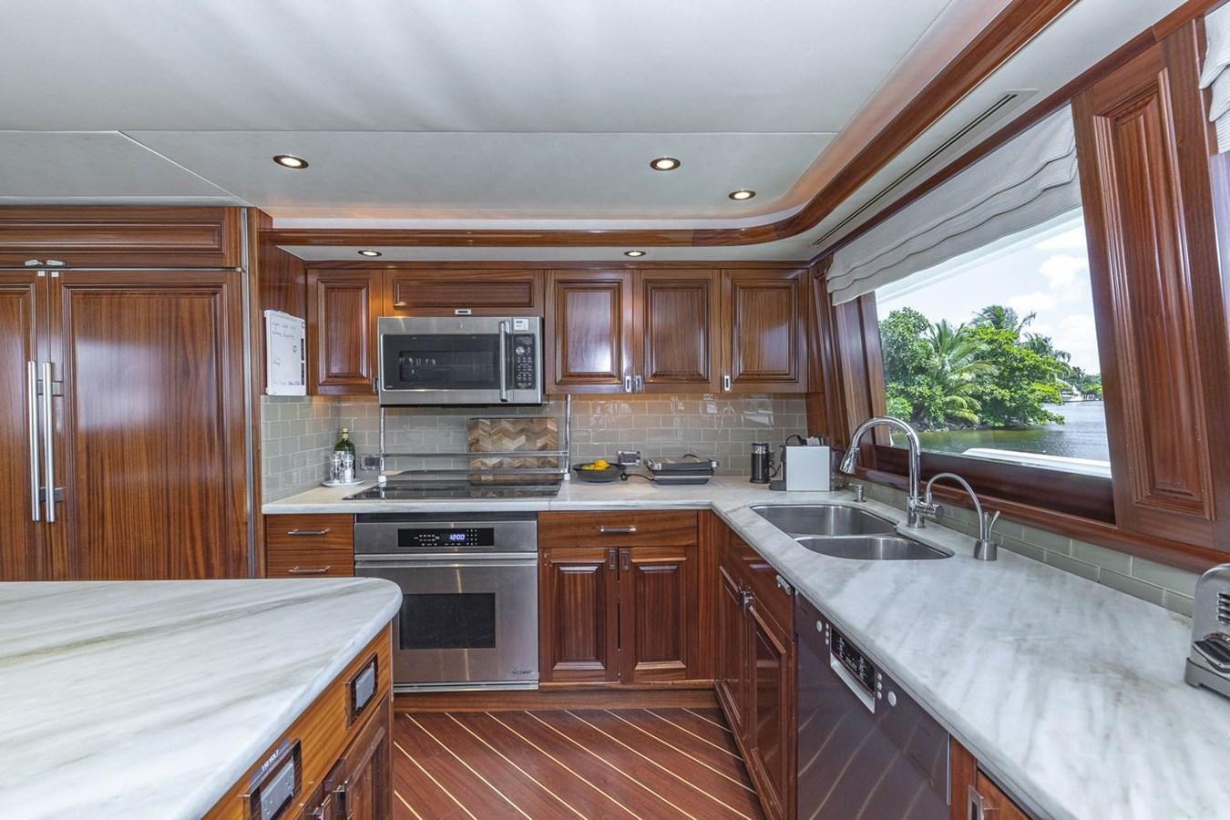 a kitchen with wooden cabinets aboard SIMPLICITY Yacht for Sale