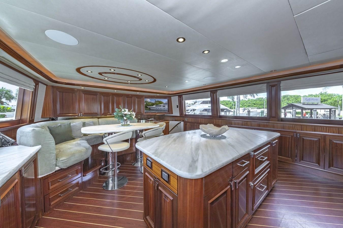 a kitchen with a table and chairs aboard SIMPLICITY Yacht for Sale