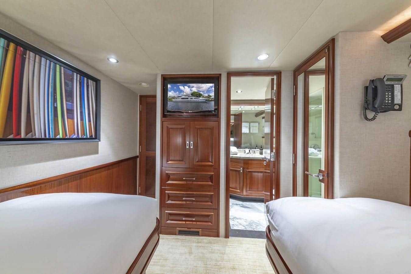 a bedroom with a bed and a television aboard SIMPLICITY Yacht for Sale