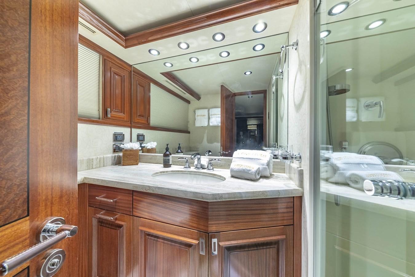 a bathroom with a large mirror aboard SIMPLICITY Yacht for Sale