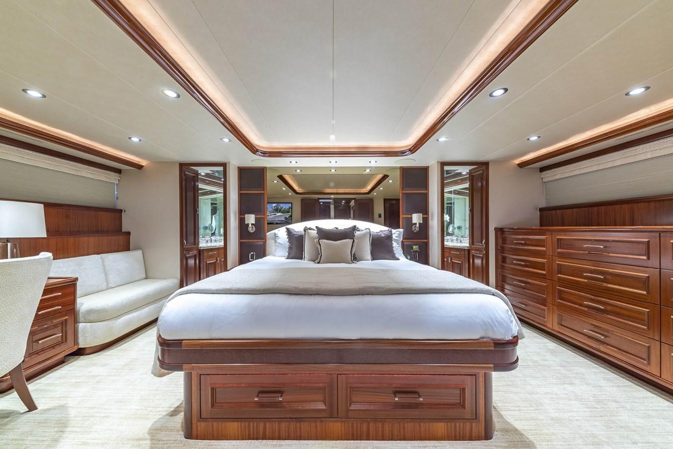 a bedroom with a bed and a couch aboard SIMPLICITY Yacht for Sale