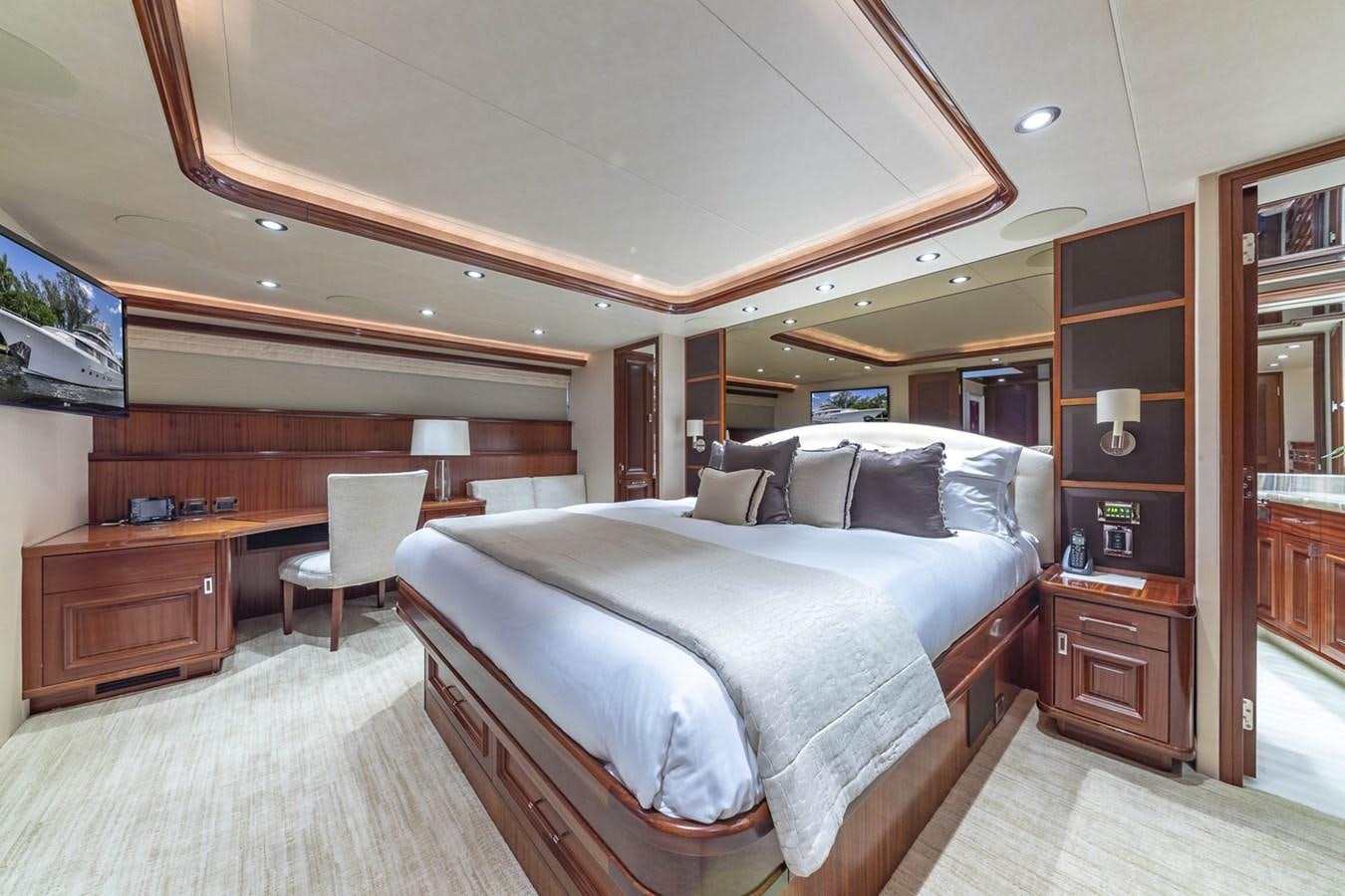 a bedroom with a bed and desk aboard SIMPLICITY Yacht for Sale