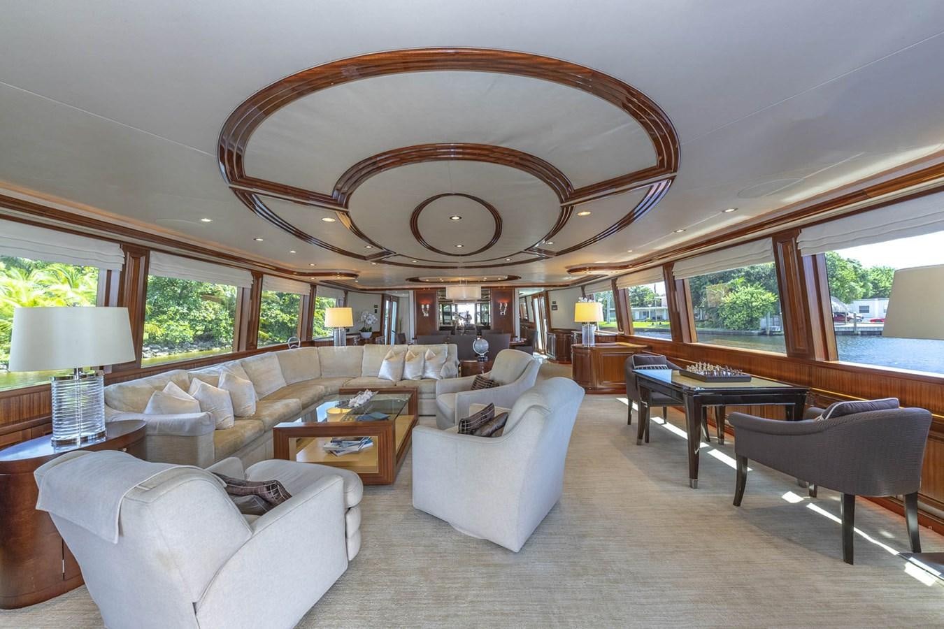 a living room with a large chandelier aboard SIMPLICITY Yacht for Sale