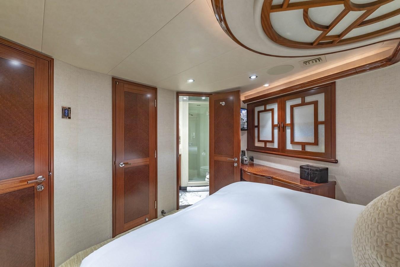 a bedroom with a bed and a closet aboard SIMPLICITY Yacht for Sale