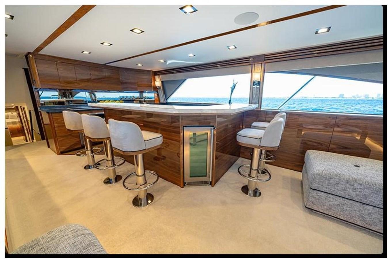 a room with chairs and a couch aboard NEW VIKING 90 SKYBRIDGE Yacht for Sale