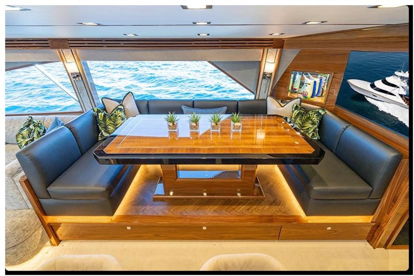 a living room with a large table aboard NEW VIKING 90 SKYBRIDGE Yacht for Sale