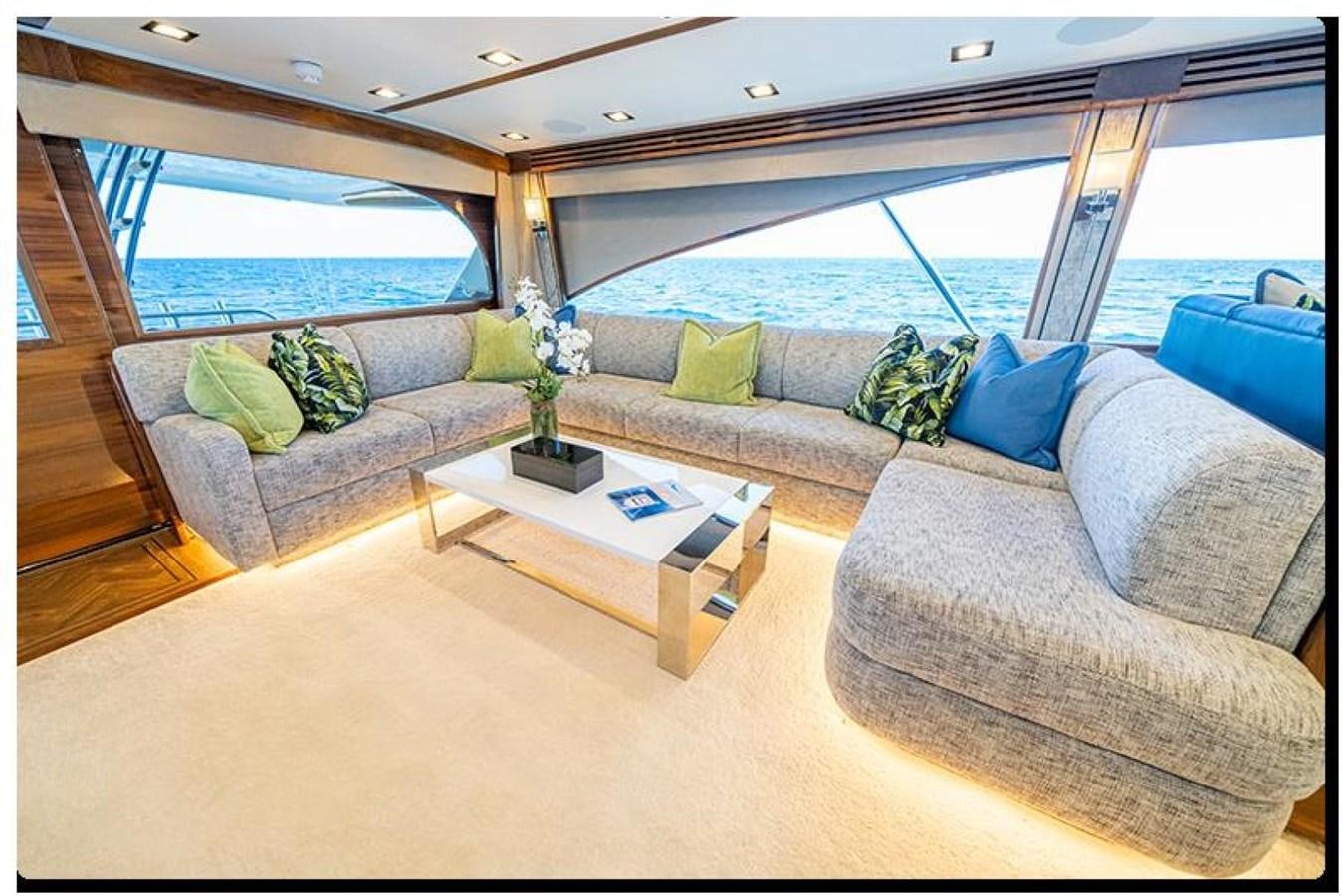 a living room with a couch and a table aboard NEW VIKING 90 SKYBRIDGE Yacht for Sale