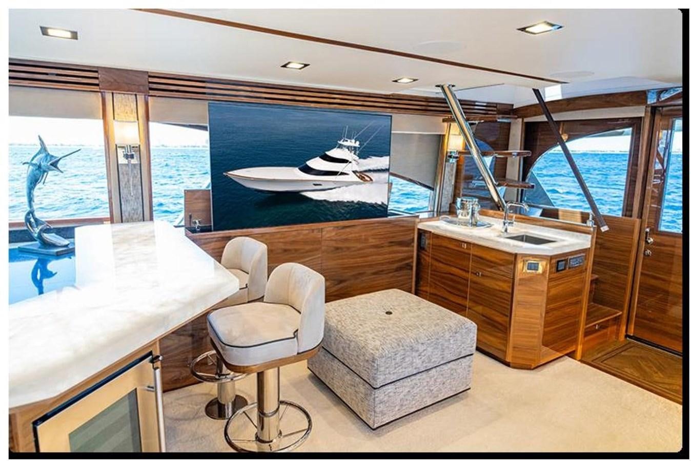 a room with a table and chairs aboard NEW VIKING 90 SKYBRIDGE Yacht for Sale