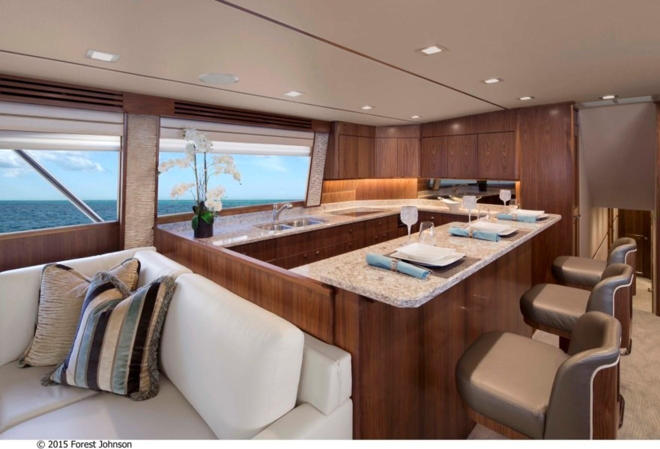 a room with a large table and chairs aboard NEW VIKING 80 SKYBRIDGE Yacht for Sale