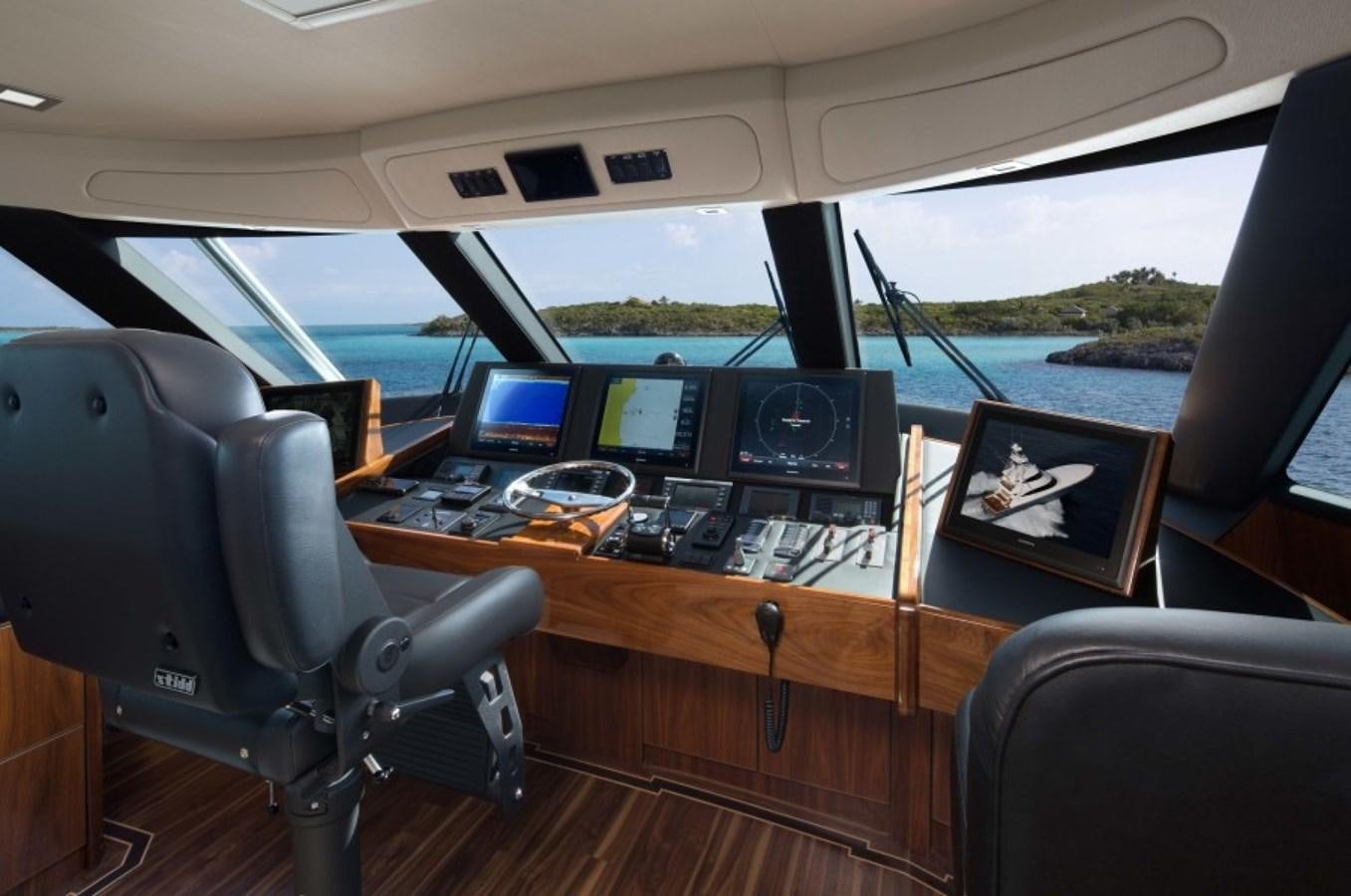 a car with a desk and computer aboard NEW VIKING 80 SKYBRIDGE Yacht for Sale