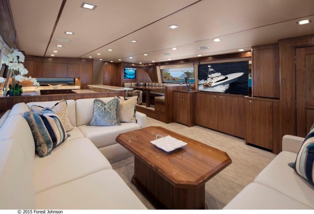 a living room with a couch and a coffee table aboard NEW VIKING 80 SKYBRIDGE Yacht for Sale