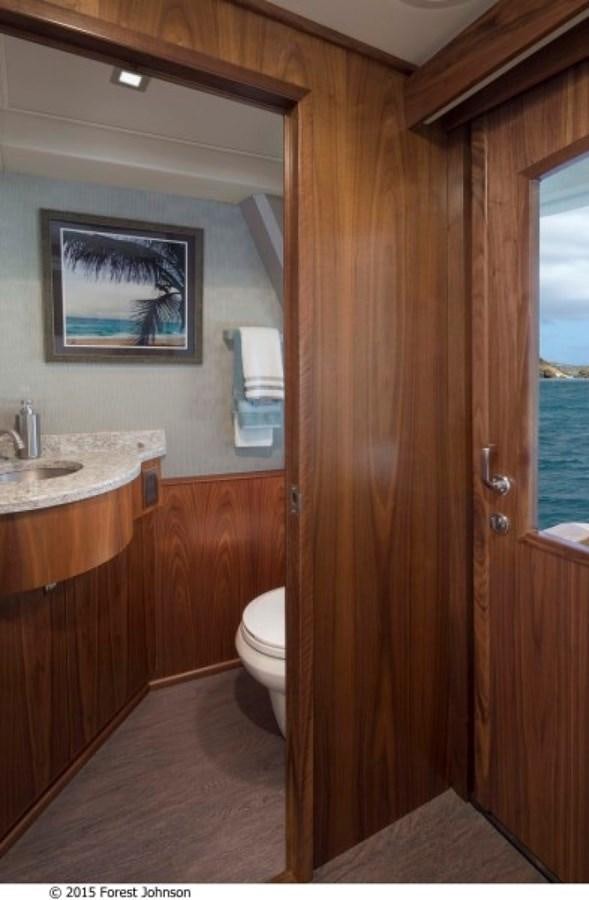 a bathroom with a sink and a toilet aboard NEW VIKING 80 SKYBRIDGE Yacht for Sale