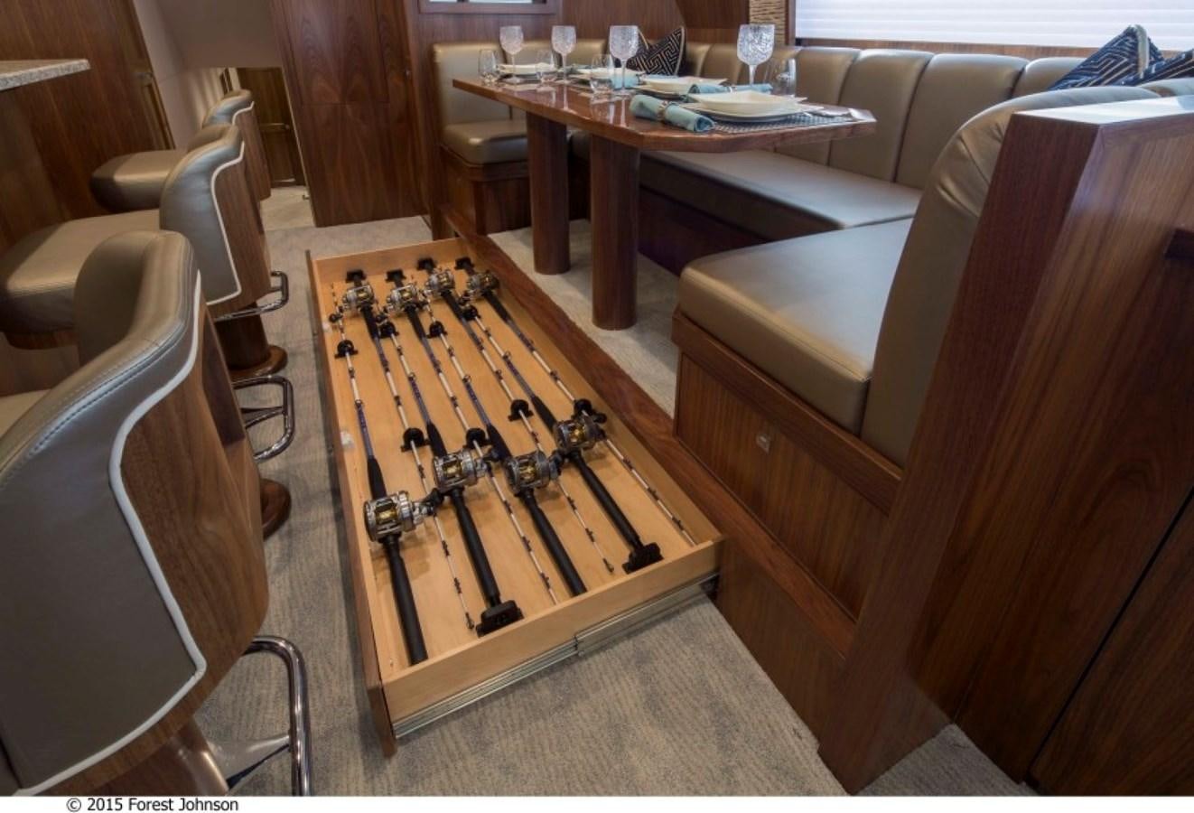 a table and chairs in a room aboard NEW VIKING 80 SKYBRIDGE Yacht for Sale