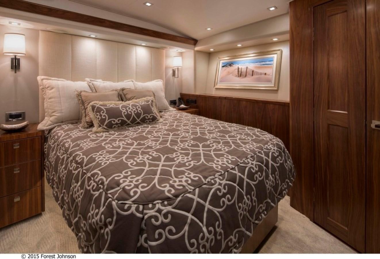 a bed with a black and white comforter and pillows aboard NEW VIKING 80 SKYBRIDGE Yacht for Sale