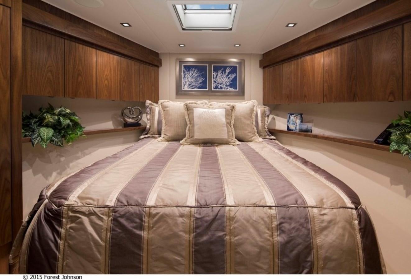 a bed with a brown comforter aboard NEW VIKING 80 SKYBRIDGE Yacht for Sale