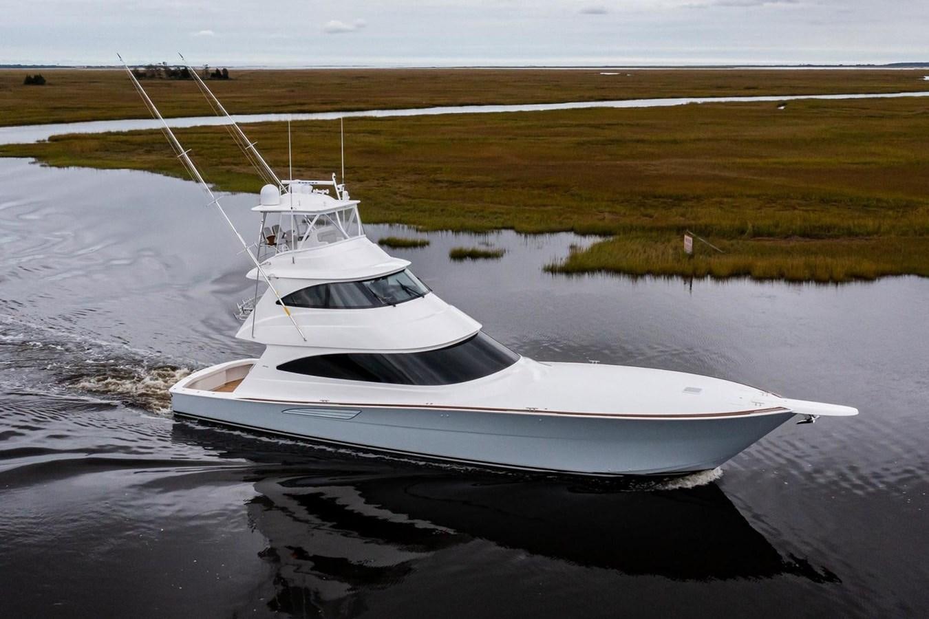 a white boat on the water aboard NEW VIKING 72 ENCLOSED BRIDGE Yacht for Sale