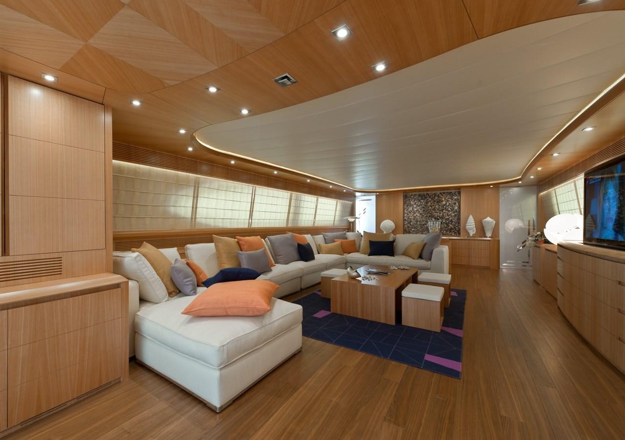 a living room with a large blue rug and white couches aboard CYNTHIA Yacht for Sale