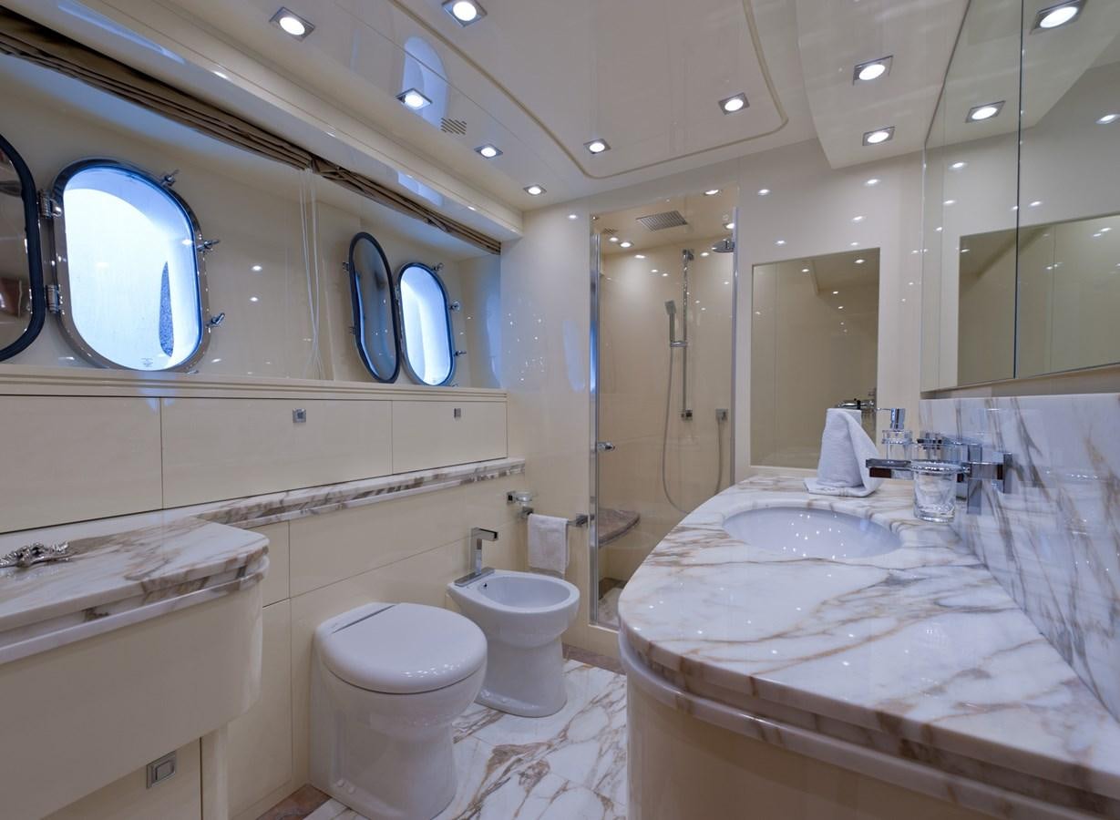 a bathroom with a sink toilet and a mirror aboard CYNTHIA Yacht for Sale