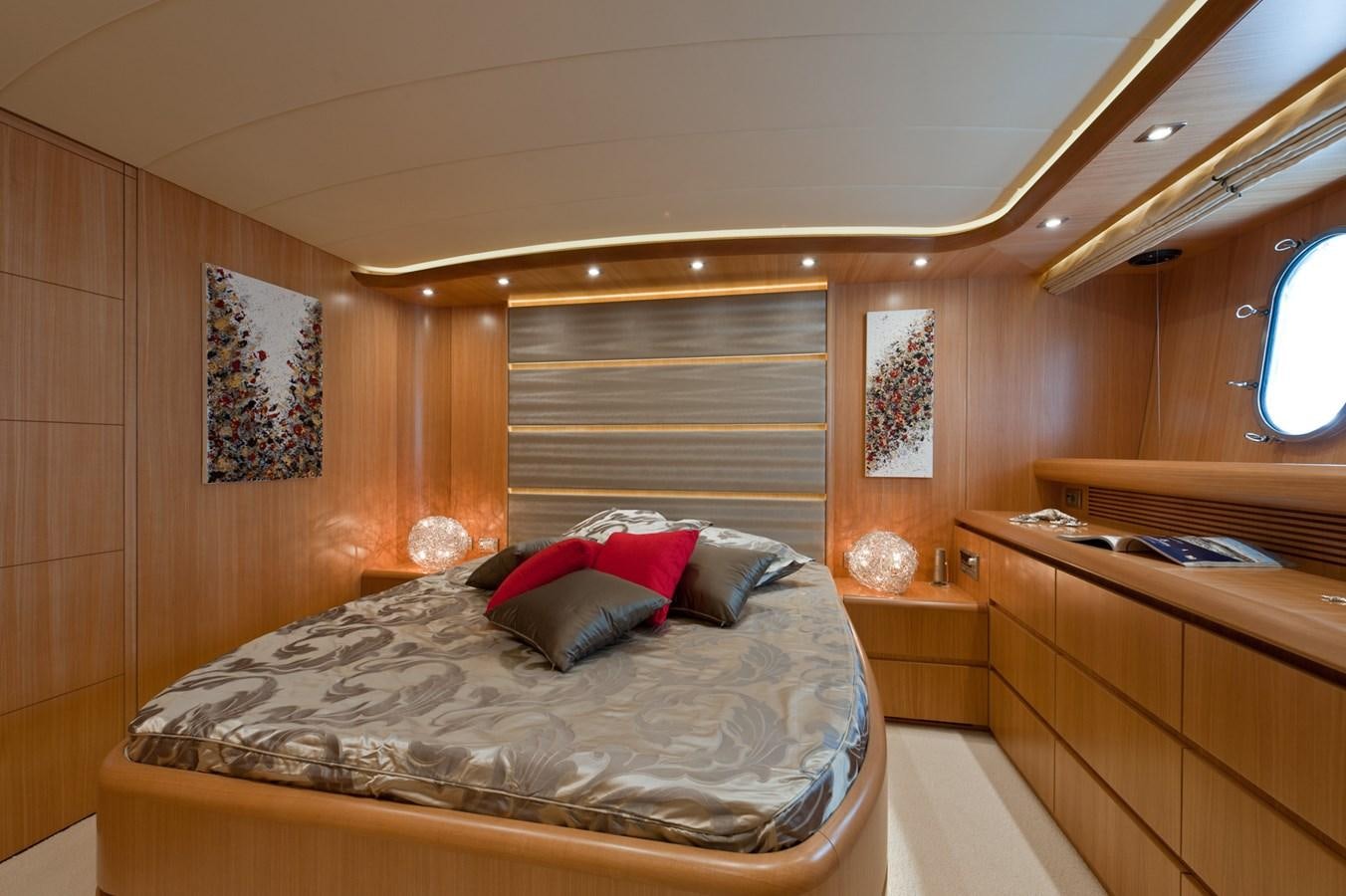 a bedroom with a bed and a window aboard CYNTHIA Yacht for Sale