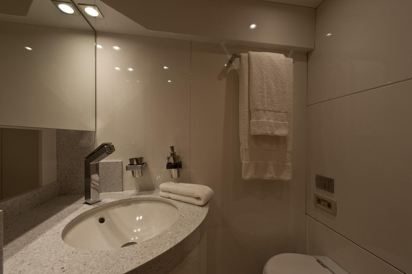 a bathroom with a sink and towels aboard CYNTHIA Yacht for Sale