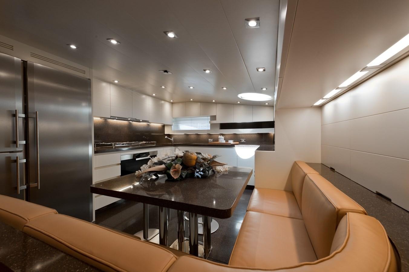 a kitchen with a table and chairs aboard CYNTHIA Yacht for Sale