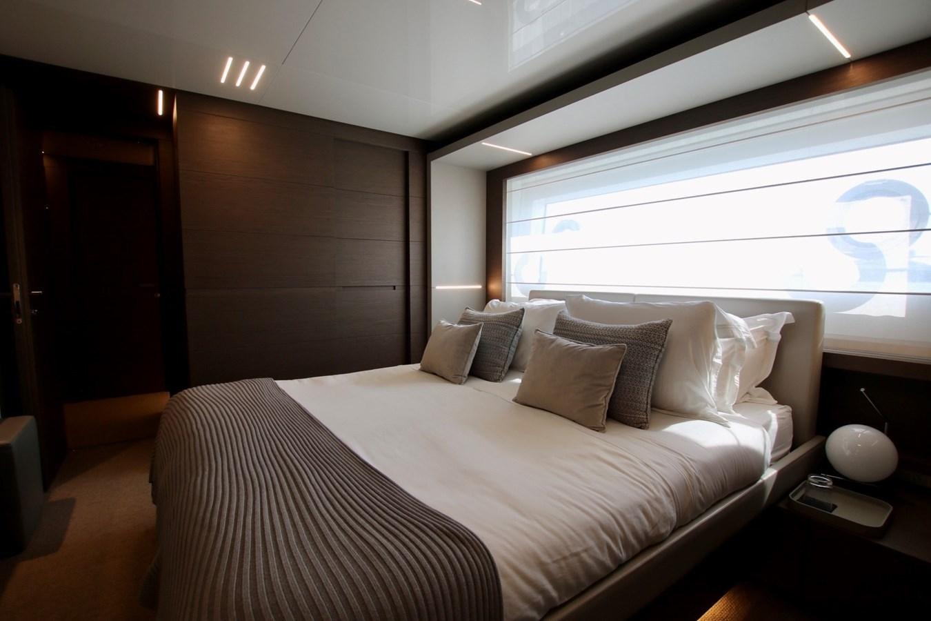 a bed with a white bed spread aboard WILLPOWER Yacht for Sale