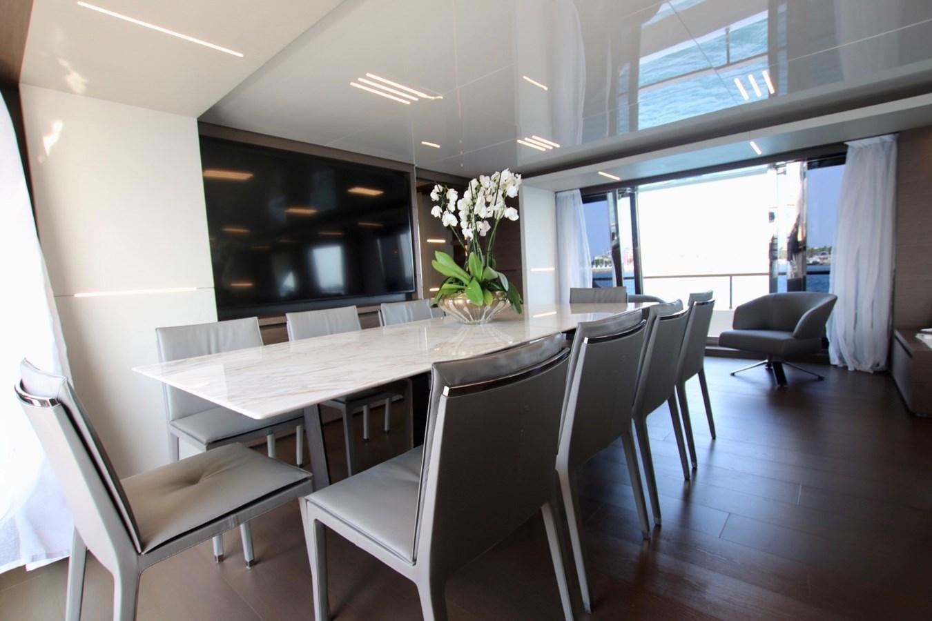 a room with a table chairs and a plant in it aboard WILLPOWER Yacht for Sale