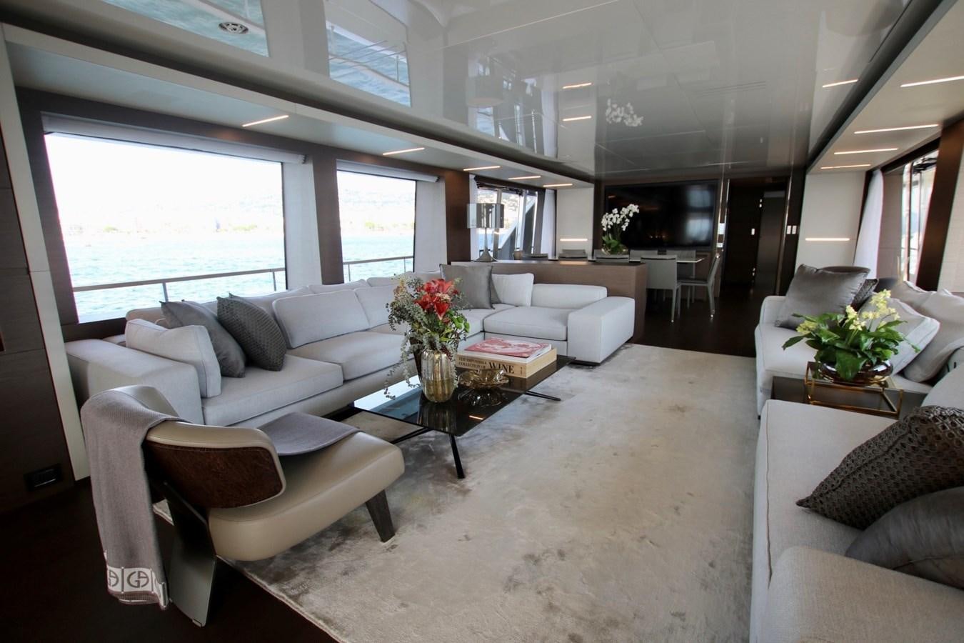 a living room with white furniture aboard WILLPOWER Yacht for Sale