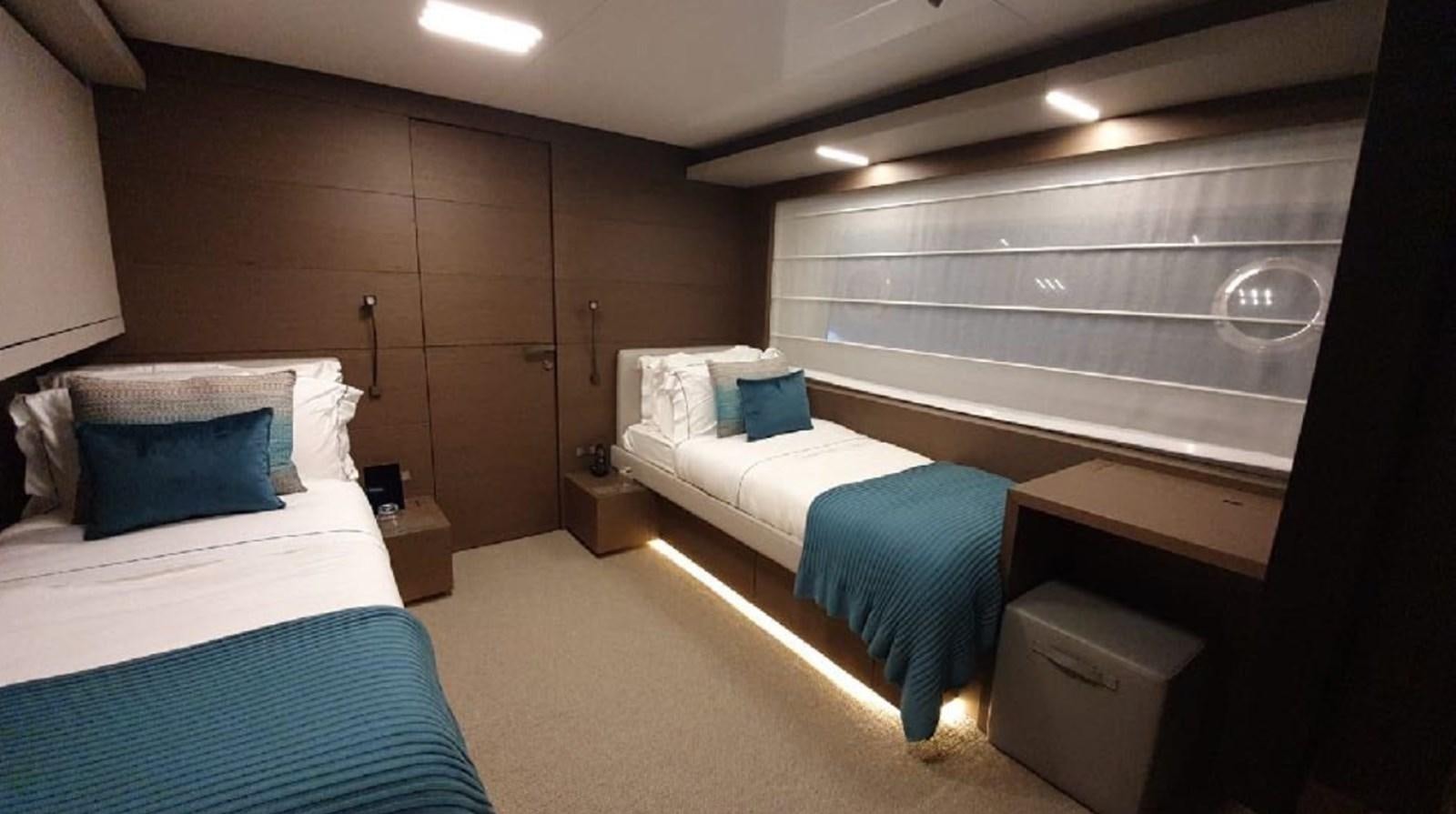 a room with beds and a tv aboard WILLPOWER Yacht for Sale